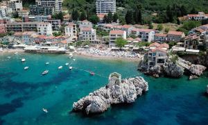 an aerial view of a beach with boats in the water at Kazanegra Exclusive Apartments in Sveti Stefan