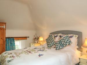 a bedroom with a bed with two pillows on it at The Old Laundry in North Tawton