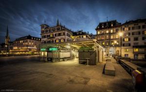 a group of buildings in a city at night at One and Only Rooftop in Zürich