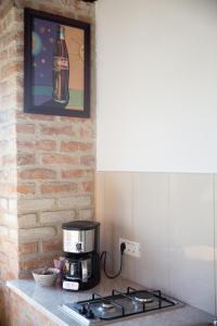 a kitchen with a coffee maker on a stove at Sea View Vama Veche - adults only in Vama Veche