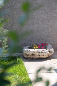 a large stone planter with flowers in it at Sea View Vama Veche in Vama Veche