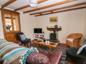 a living room with a couch and a fireplace at Llety in Fishguard