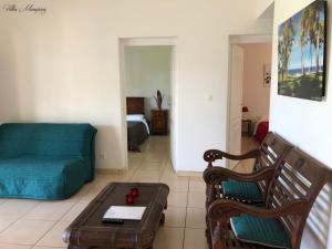 a living room with a couch and a coffee table at Villas Manapany in Saint-Joseph