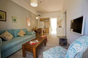 a living room with a blue couch and a table at Athens Central Apartment 2 mins to metro in Athens