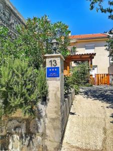 a street sign in front of a house at Jasmina in Senj