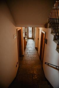 a hallway with stairs leading up to a room at Hotel Larice in Livigno