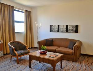 a living room with a couch and a table at The Centurion Hotel in Centurion