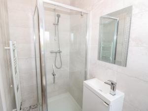 a bathroom with a shower and a toilet and a sink at 5 Yarmouth Cottages in Freshwater +18 photos