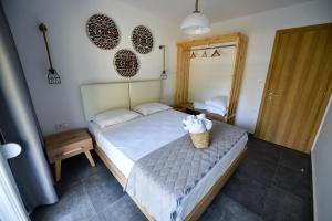 A bed or beds in a room at Lamda Deluxe Apartments