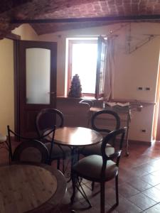 a dining room with tables and chairs and a window at Agriturismo Doremi in Vignolo