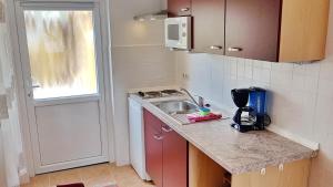 a small kitchen with a sink and a microwave at Ferienzimmer *Auszeit* in Sassnitz