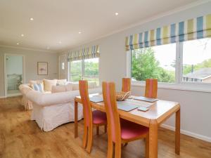 a living room with a table and a couch at Lavender Lodge in Bideford