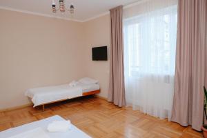 a bedroom with a bed and a large window at Keti&Tatia Sisters Apartment - near Old and Central Tbilisi in Tbilisi City