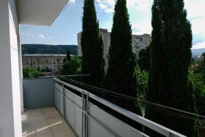 a balcony with trees and a building at Keti&Tatia Sisters Apartment - near Old and Central Tbilisi in Tbilisi City