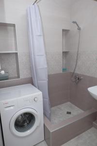 a bathroom with a washing machine and a sink at Keti&Tatia Sisters Apartment - near Old and Central Tbilisi in Tbilisi City