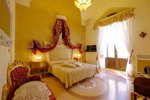 A bed or beds in a room at Palazzo Gallo Resort