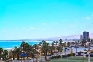 a view of the beach from the balcony of a resort at Apartamentos Alma Surire in Arica +10 photos