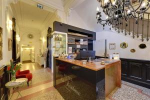 a large room with a desk with a computer on it at Hôtel La Résidence in Narbonne