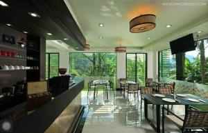 a dining room with tables and chairs in a room at Kamala Villa Hill in Kamala Beach