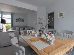 a dining room with a wooden table and chairs at Southview Retreat in Weymouth