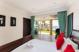 a bedroom with a bed and a view of the ocean at Ballito Manor - Manor View 102 in Ballito