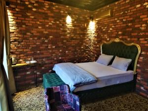 a bedroom with a bed in a brick wall at Kayıbeyi Hotel & Restaurant in Bursa
