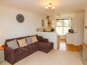 a living room with a couch and a clock on the wall at Seashore in Woolacombe