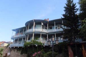 a large blue building with a balcony at Apartment in Old Tbilisi Orbeliani Square in Tbilisi City