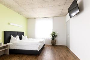 Postel nebo postele na pokoji v ubytování Partner Hotel AG Zofingen