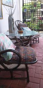 a table and chairs with a table and a glass table and chairs at Forestview guesthouse and B&B in Sedgefield