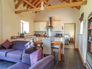 a living room with a couch and a table at Y Bwthyn in Llanfairpwllgwyngyll +11 photos