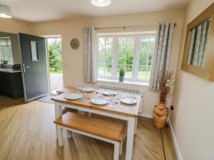 a dining room with a table and a window at Ryedale Country Lodges - Willow Lodge in York