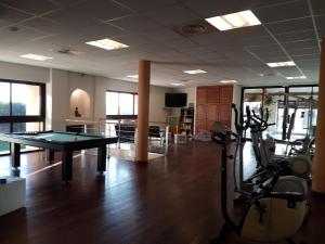a room with a ping pong table and a gym at Domaine De L'aube Des Temps in Raissac-dʼAude