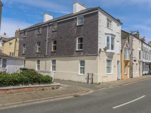 a large brick building on the side of a street at Gadlys House - Waters Edge in Beaumaris