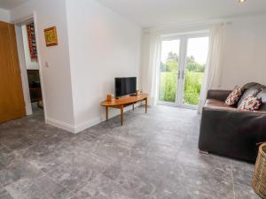 a living room with a couch and a table at The Stables in Frodsham