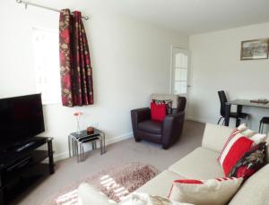 a living room with a couch and a chair at The Bungalow in Burnley