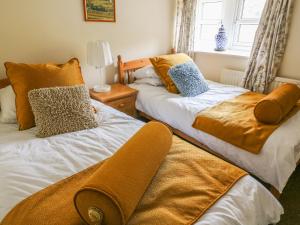two beds sitting next to each other in a room at Dale View in Skipton