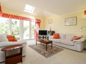 a living room with two couches and a tv at 27 Wick Lane in Christchurch