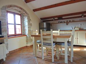 a kitchen with a table and chairs in a room at Car free island Unije Gasparini apartments in Unije