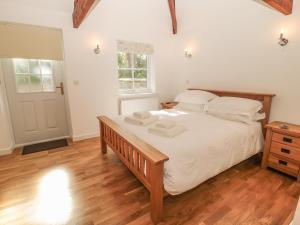 En eller flere senge i et værelse på Nursery Cottage