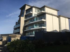 a tall building with balconies on the side of it at Ocean View Beach Rd in Newquay