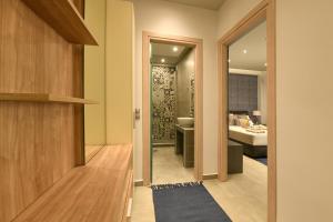 a hallway leading to a bathroom with a bedroom at Sunny Luxury Suite Stone in Kavála +13 photos