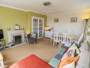 a living room with a couch and a dining room at Sea-u-Soon in Saltburn-by-the-Sea