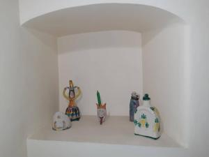 a group of vases sitting on a white shelf at B&B Il Nespolo in Salerno