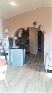 an open kitchen and living room with an archway at La Tour aux Tilleuls in Lorlanges