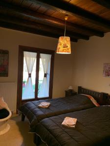 a bedroom with a bed and a large window at Villa Argie in Néa Epídhavros