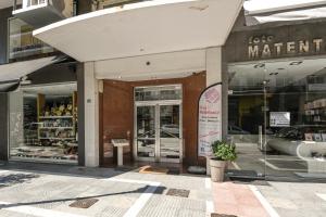 a store front with its doors open on a street at Sunny Luxury Suite Stone in Kavála
