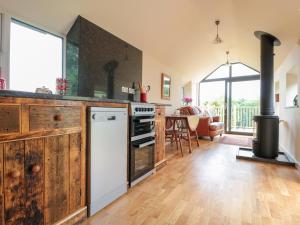 a kitchen with a stove and a dining room at The Hideout in Ross on Wye