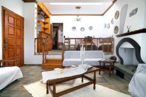 a living room with a table and a fireplace at Villa Vasiliki in Paralía Avdhíron +47 photos