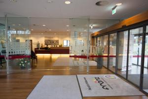 a store with glass walls and a display case at Hotel Franz in Essen